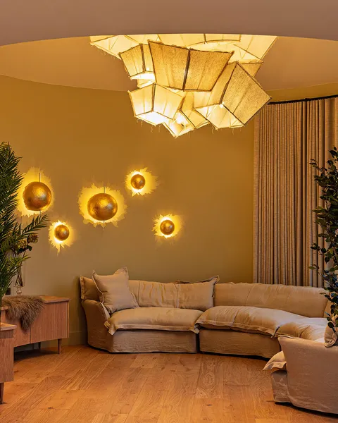 A custom configured chandelier with bespoke shades in a circular living room