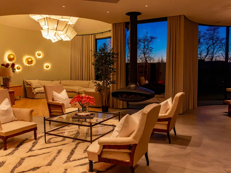 The interior of a luxury developed around agricultural silos at Blue Hour.  Warm lighting in the livign room.