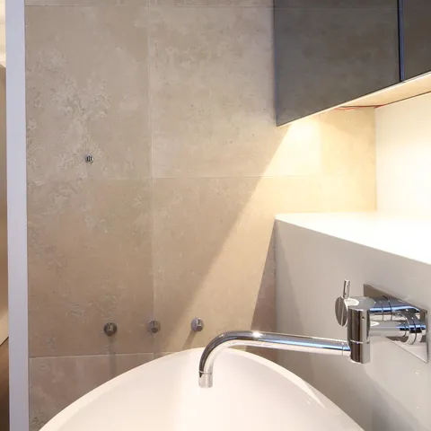 Under-cabinet LED linear lighting in a modern bathroom