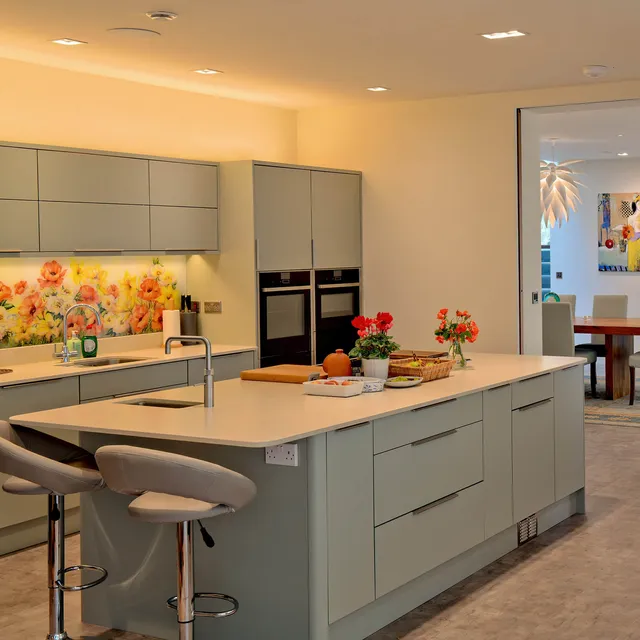 A bright modern kitchen with downlights over the island and working surfaces.