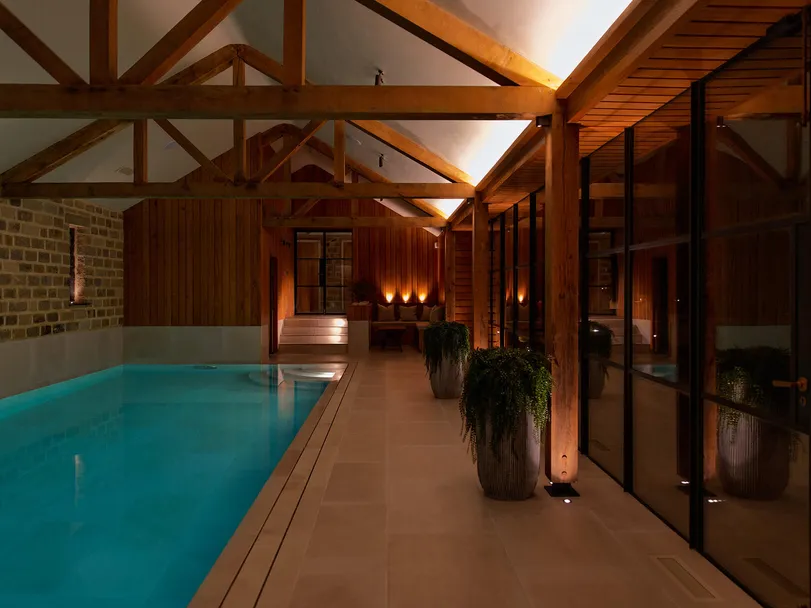 Swimming pool in a timber-beamed building - Night lighting scene