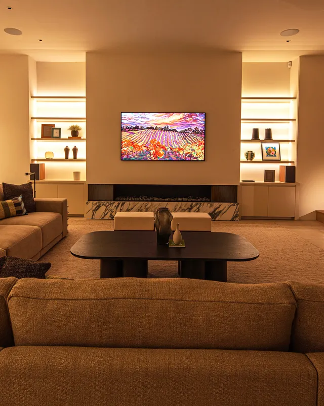 A large Samsung The Frame TV with linear LED backlit shelving 