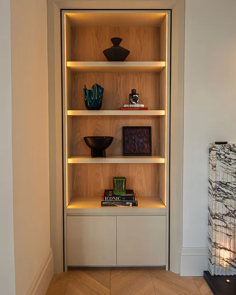 Detail of vertical linear LED lighting in shelving