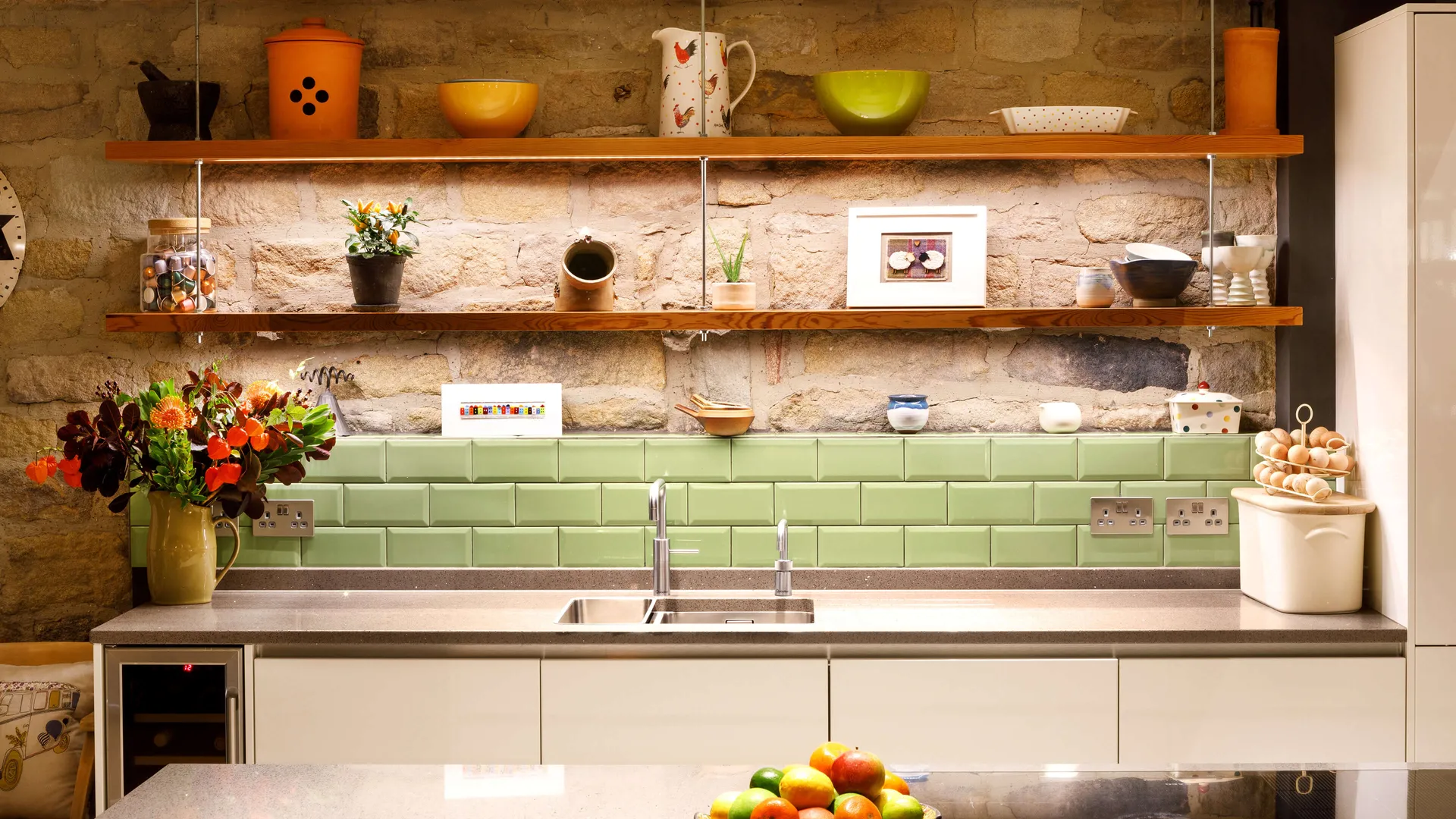 Brightly lit shelves above a kitchen sink