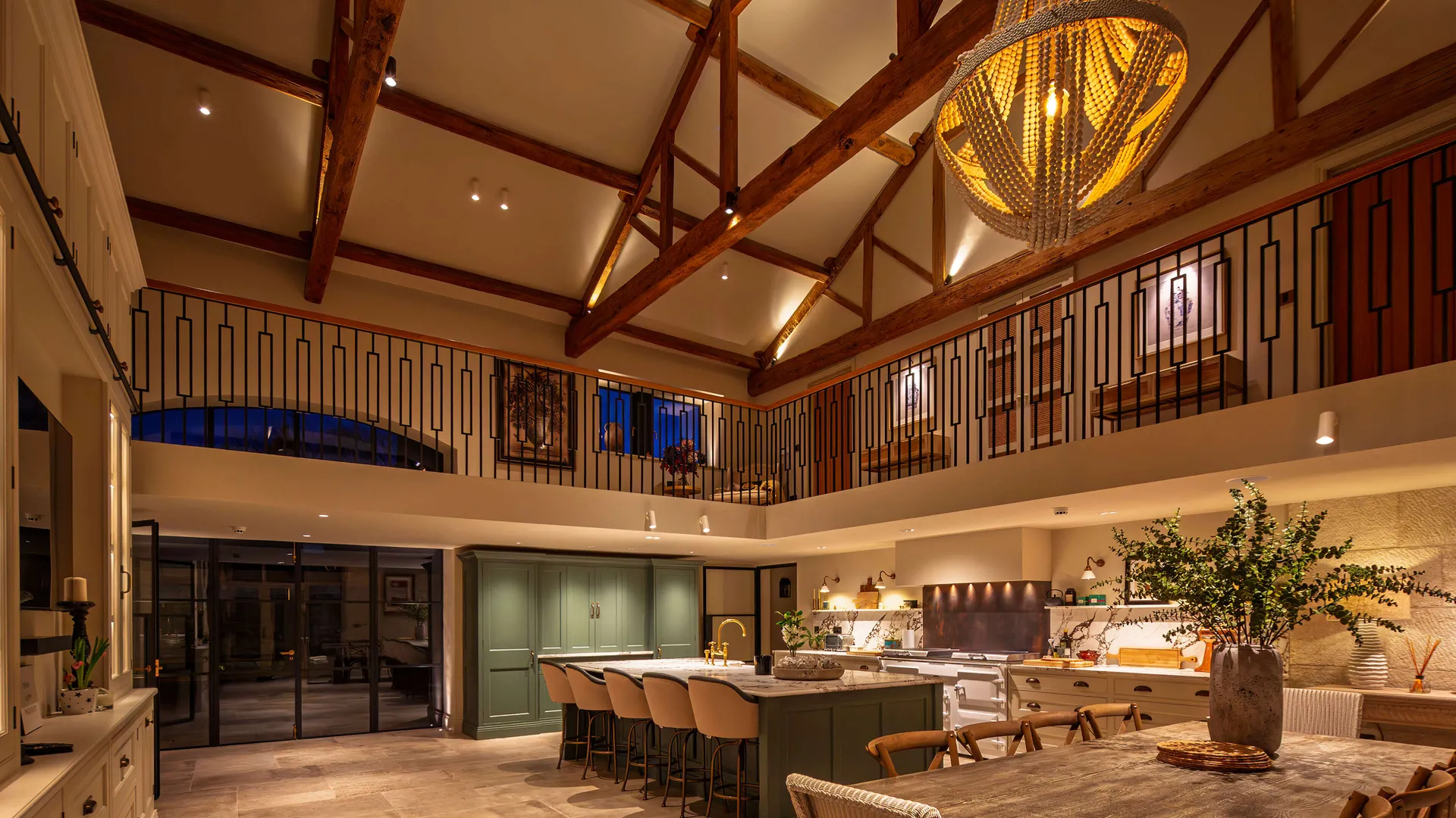 A large kitchen with a beautiful double-height beamed ceiling