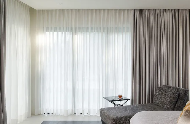 Lutron curtain track systems in a bright, airy bedroom