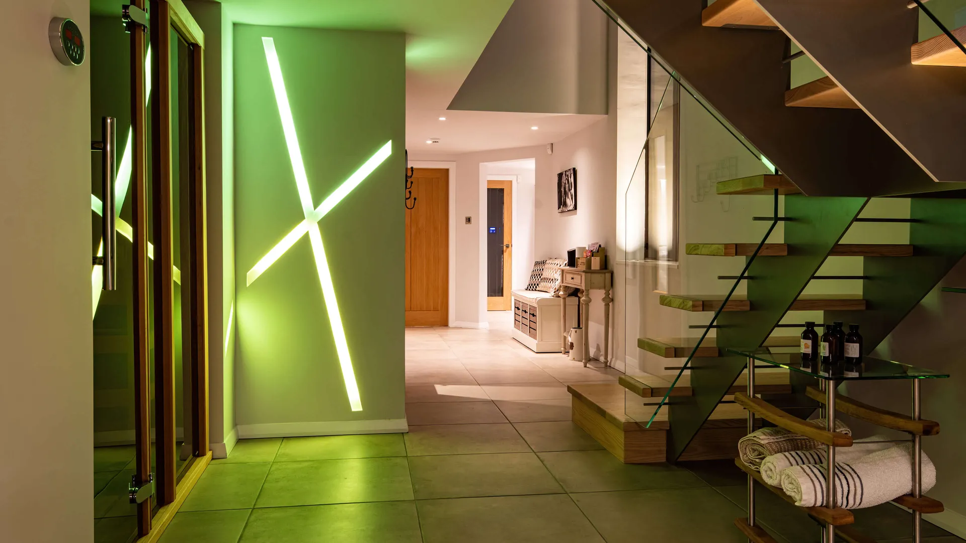 Green linear LED light in custom profiles in a colour-changing lighting sequence 